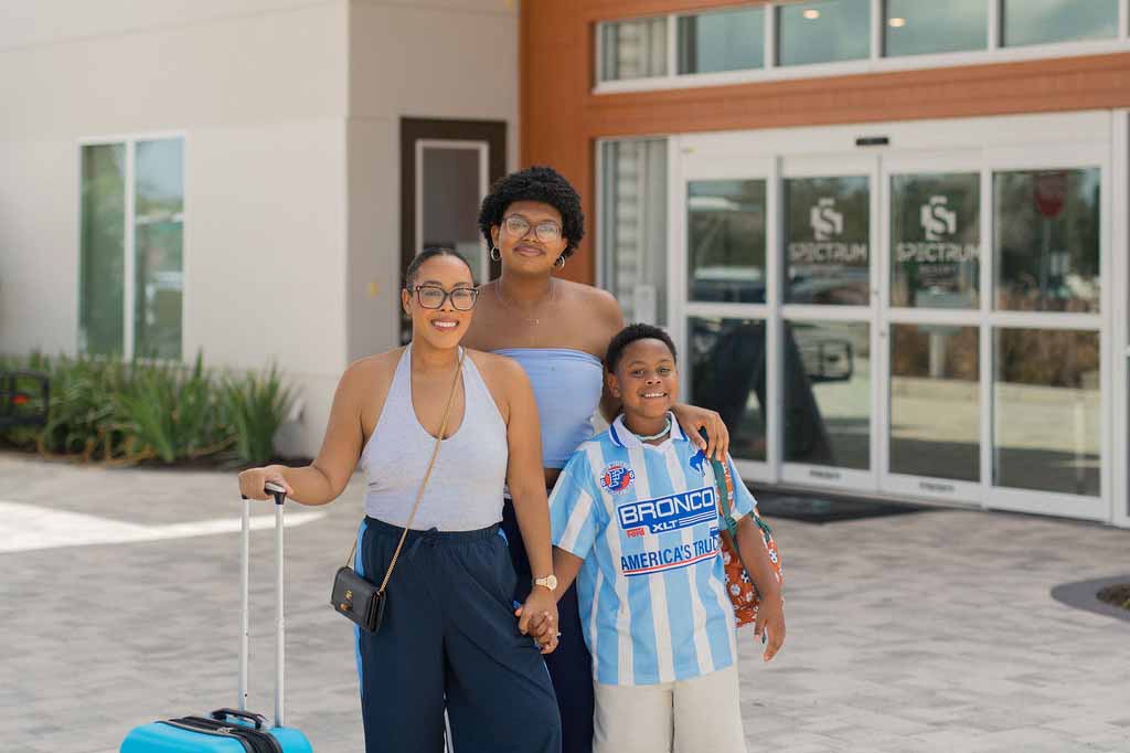 Briana Dottin and her family in front of Spectrum Resort Orlando