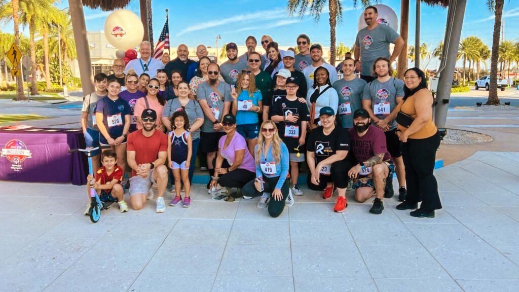 Team NDM Hospitality poses together during the 2024 Race for Inclusion at the Promenade at Sunset Walk