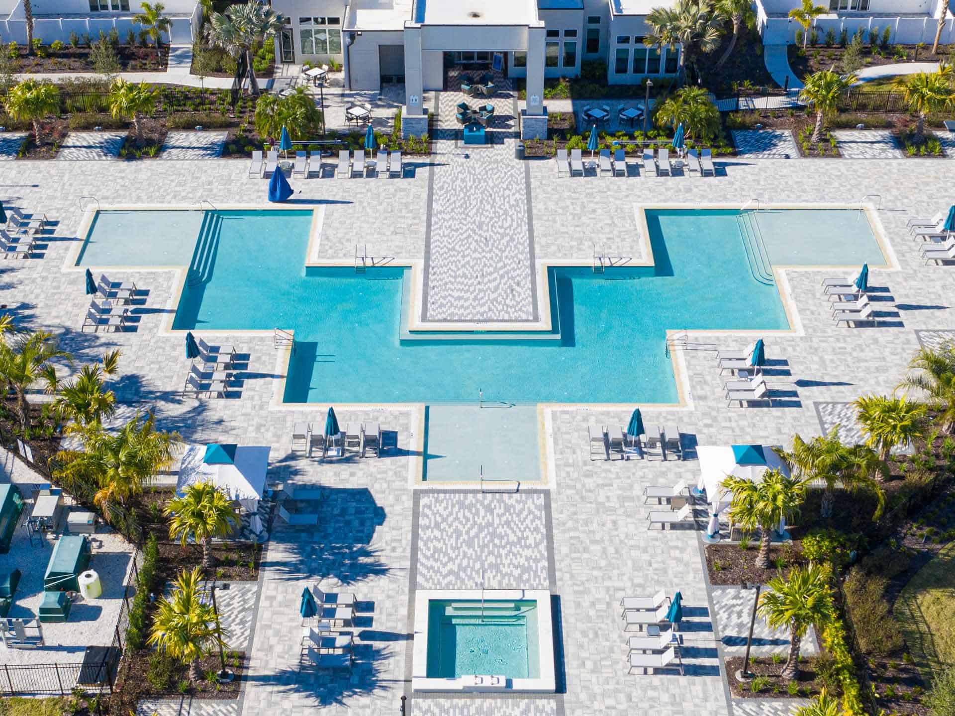 Aerial view of the Spectrum Resort Orlando pool and hot tub surrounded by lounge chairs and cabanas